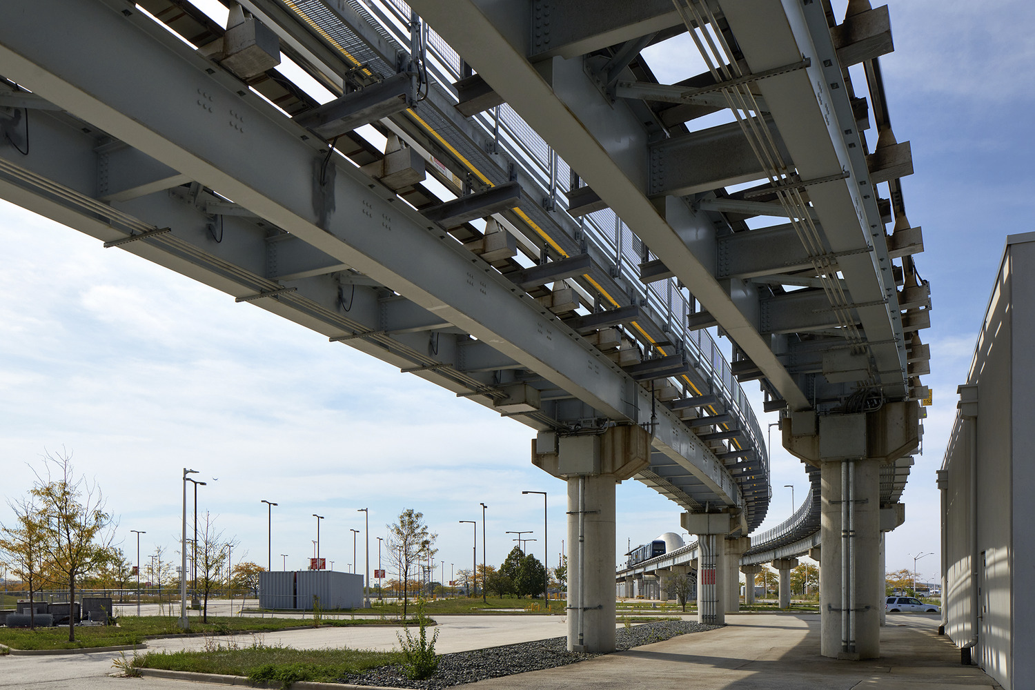 A bridge over a parking lot.