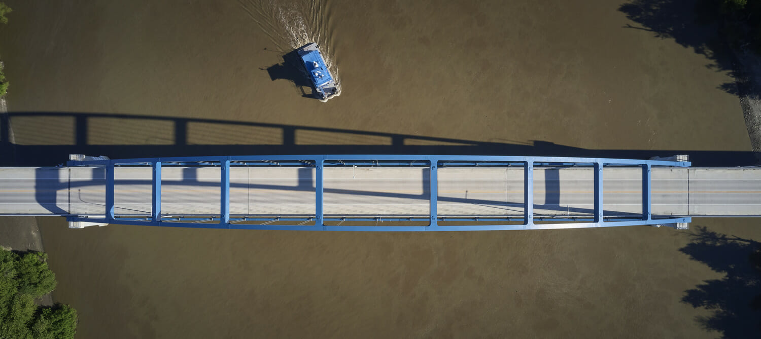 An aerial view of a bridge with a boat on it.