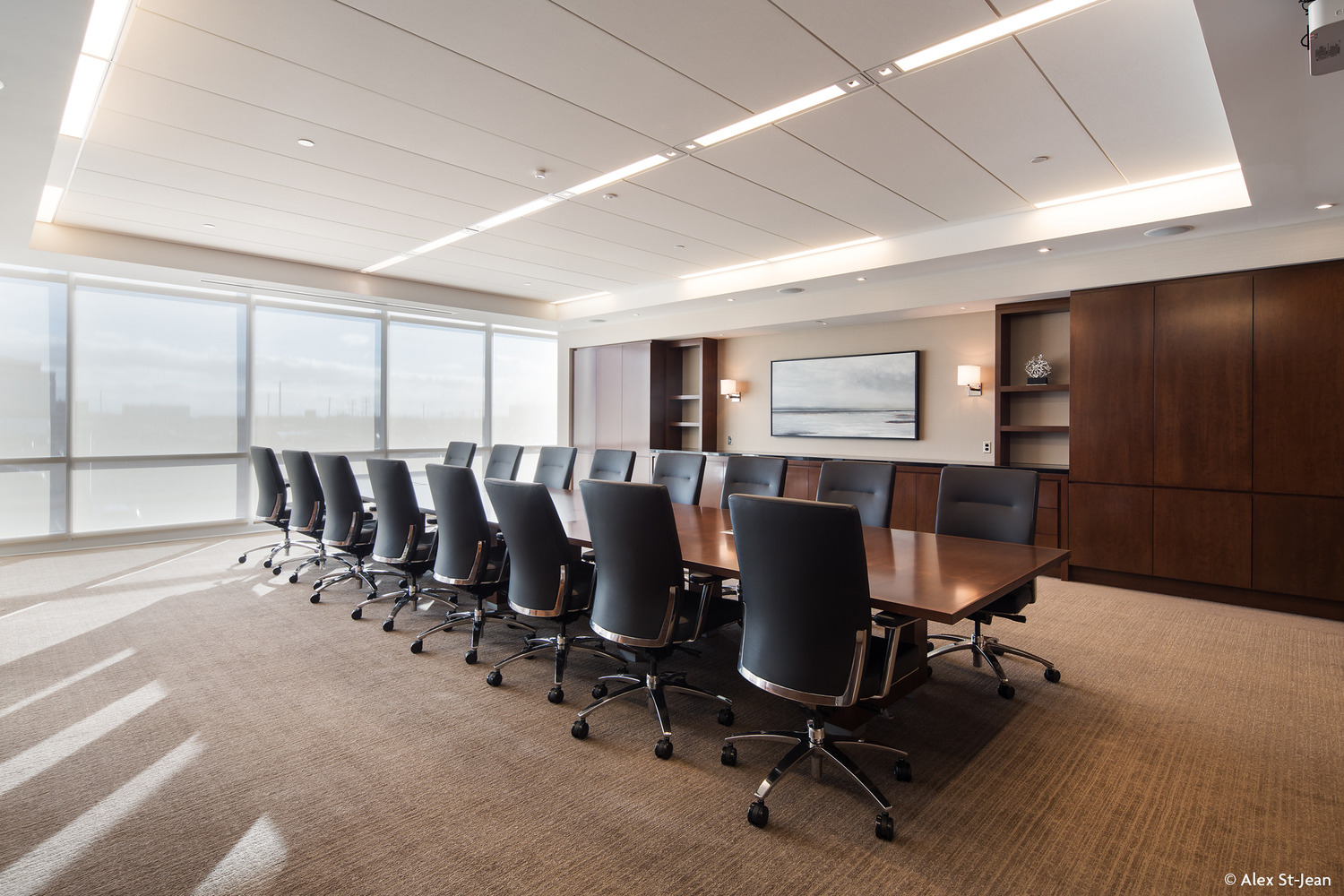 A conference room with a large table and chairs.