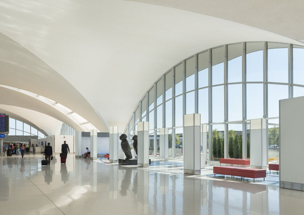 The lobby of an airport with large windows.