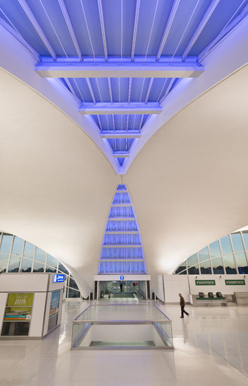 The inside of an airport with a blue ceiling.