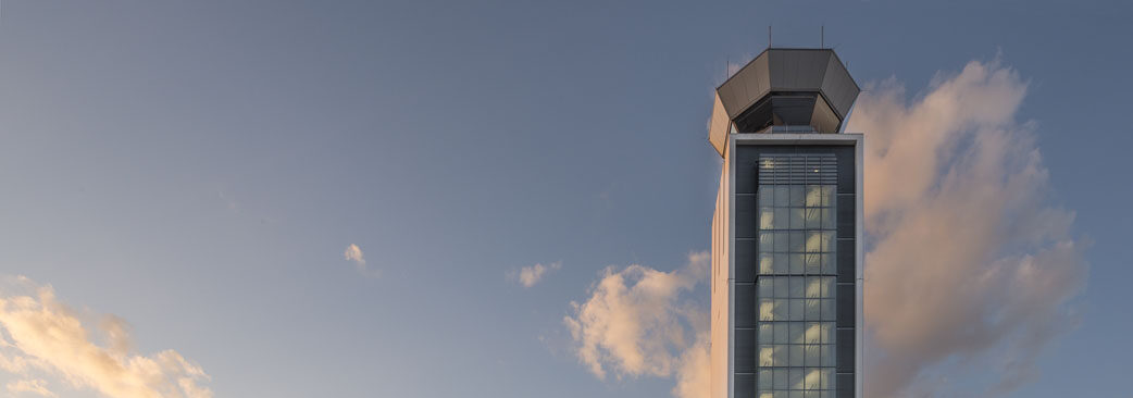 A tall building with a clock tower in the background.