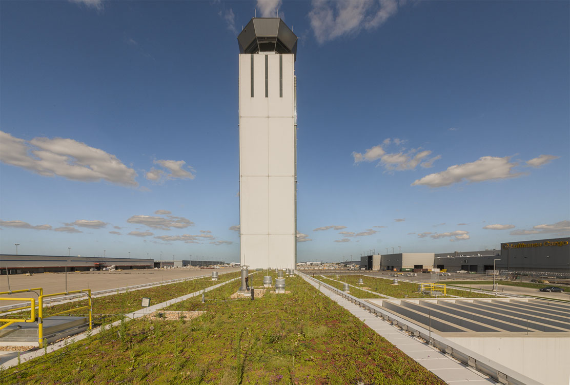 A tall building with a green roof.