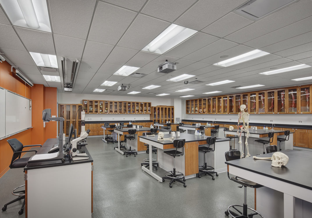 A science lab with a lot of tables and chairs.
