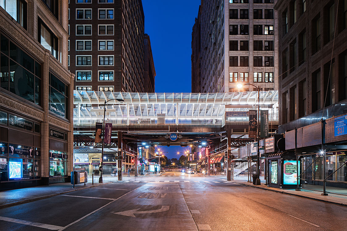 An empty street in a city at night.