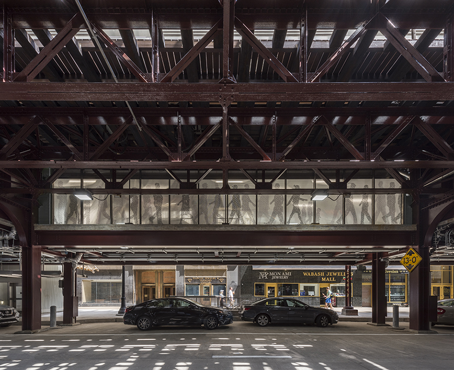 Two cars are parked in a parking garage.