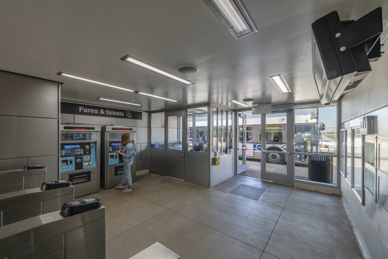 A woman is standing in a train station.