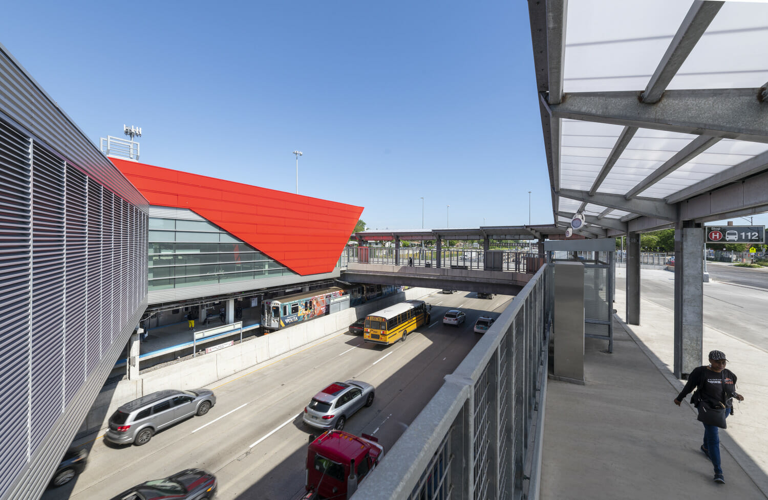 An aerial view of a bus station with a red roof.