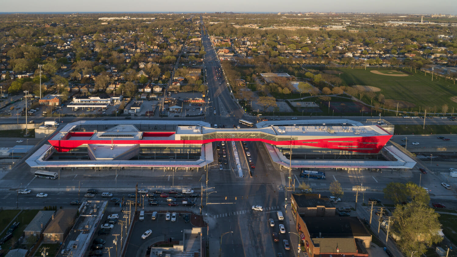 An aerial view of an intersection with a red bridge.