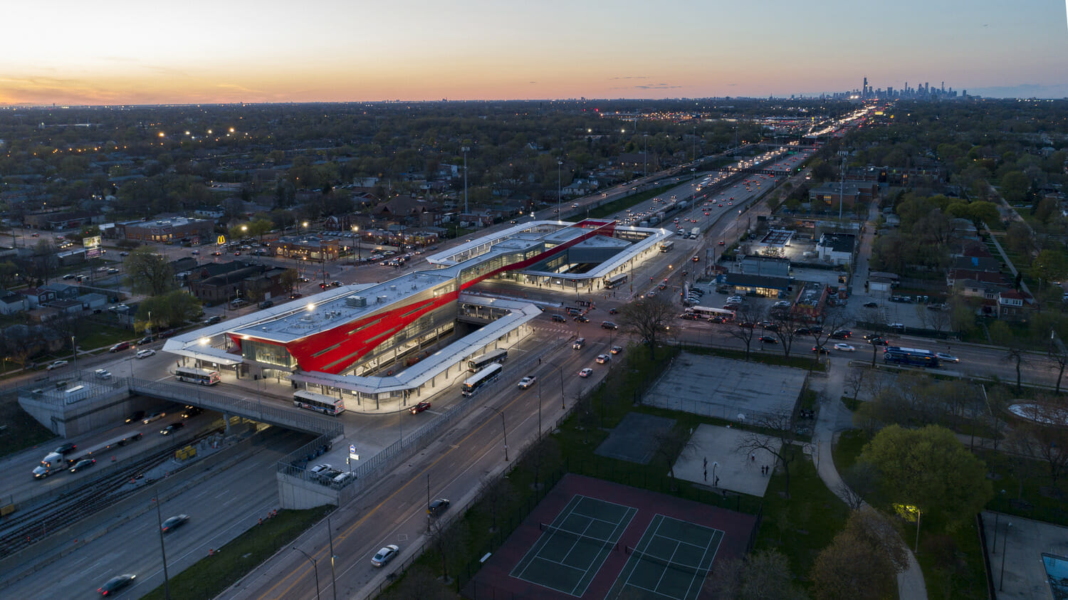 An aerial view of a train station at dusk.