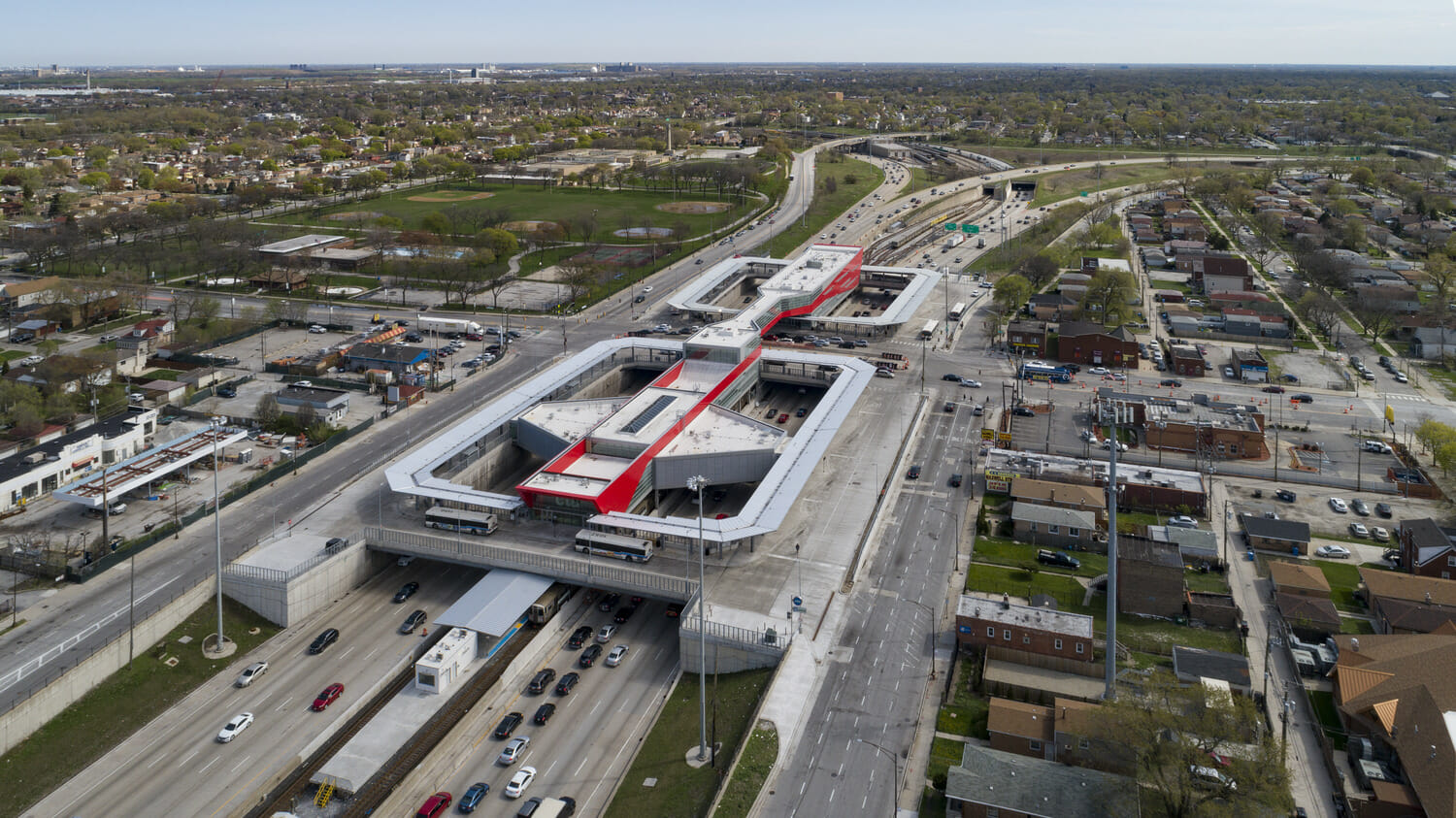 An aerial view of a city with a train station.