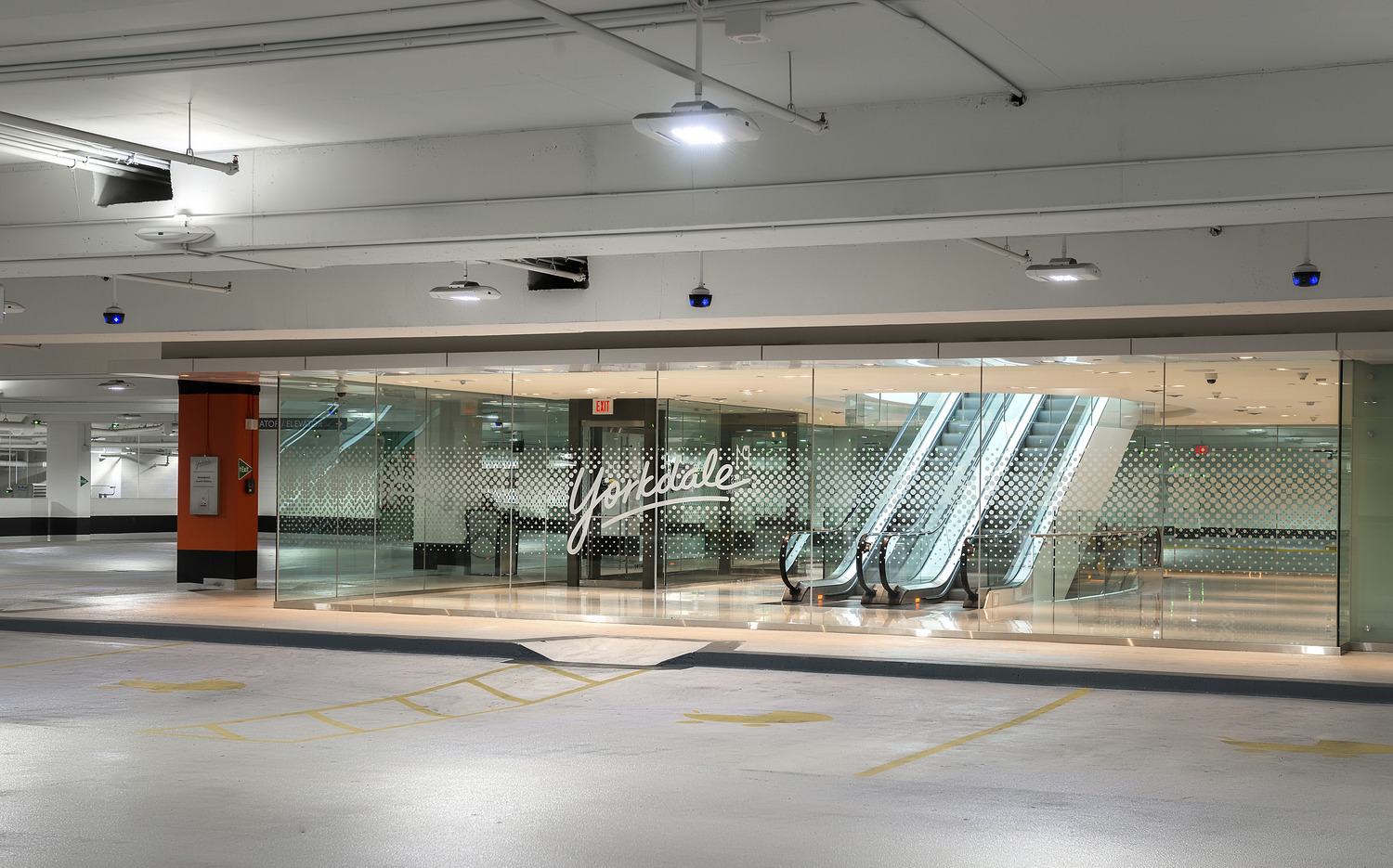 An escalator in a parking garage.