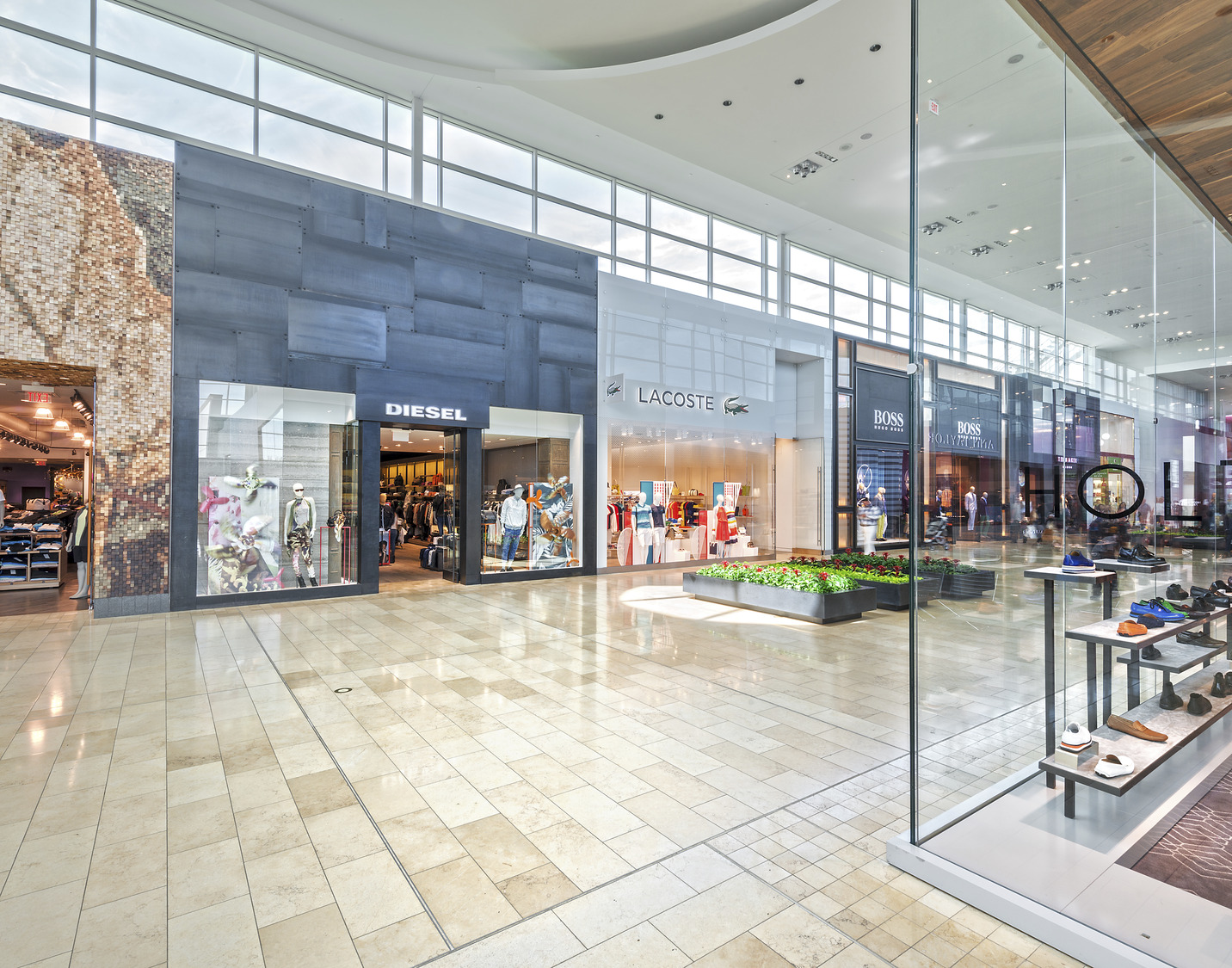 The interior of a shopping mall with a glass wall.