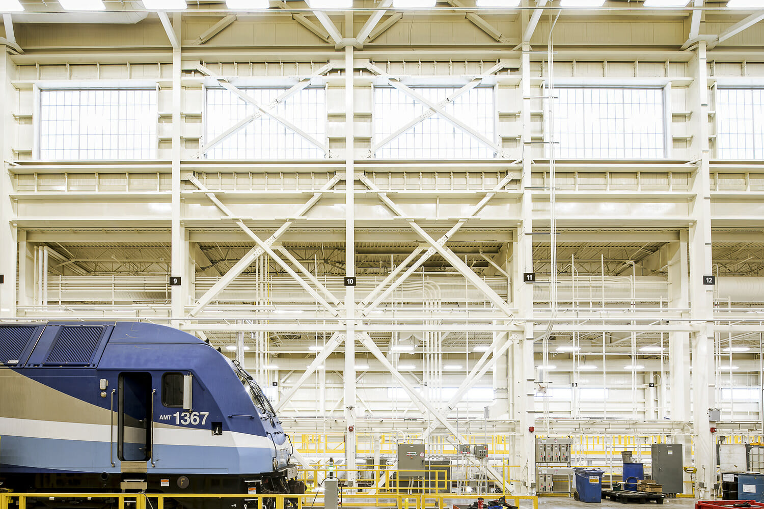 A blue and white train in a factory.