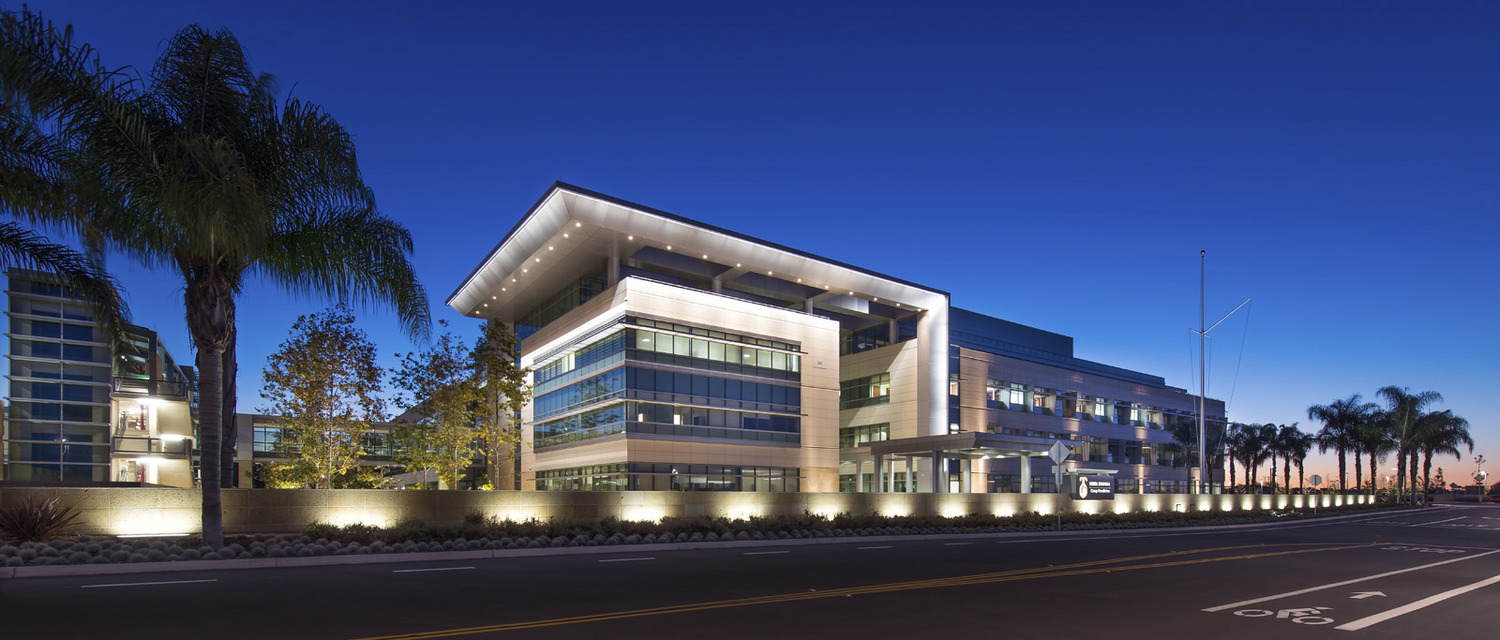 A modern office building lit up at night.