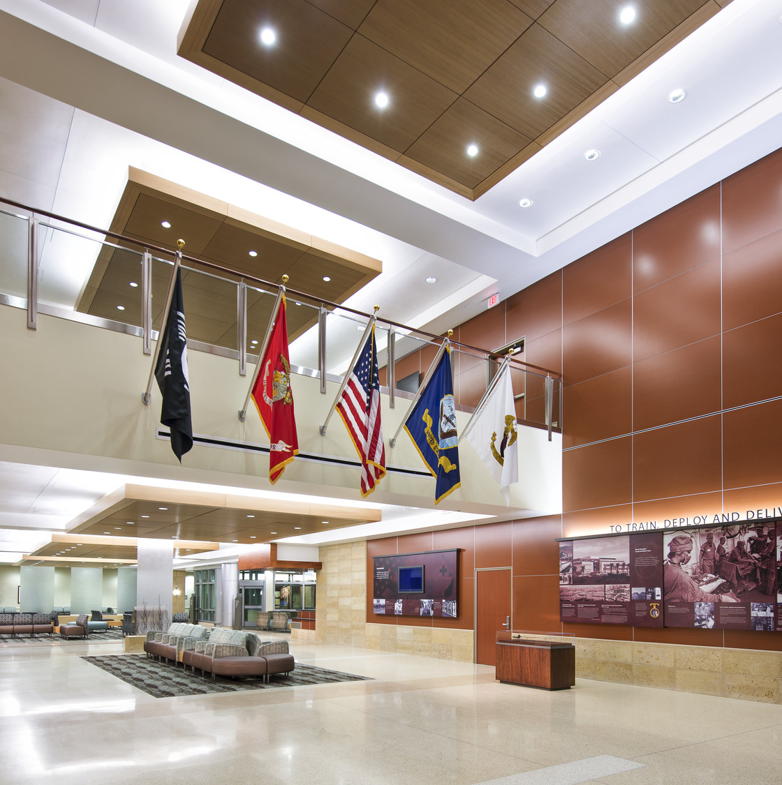 A lobby with flags hanging from the ceiling.