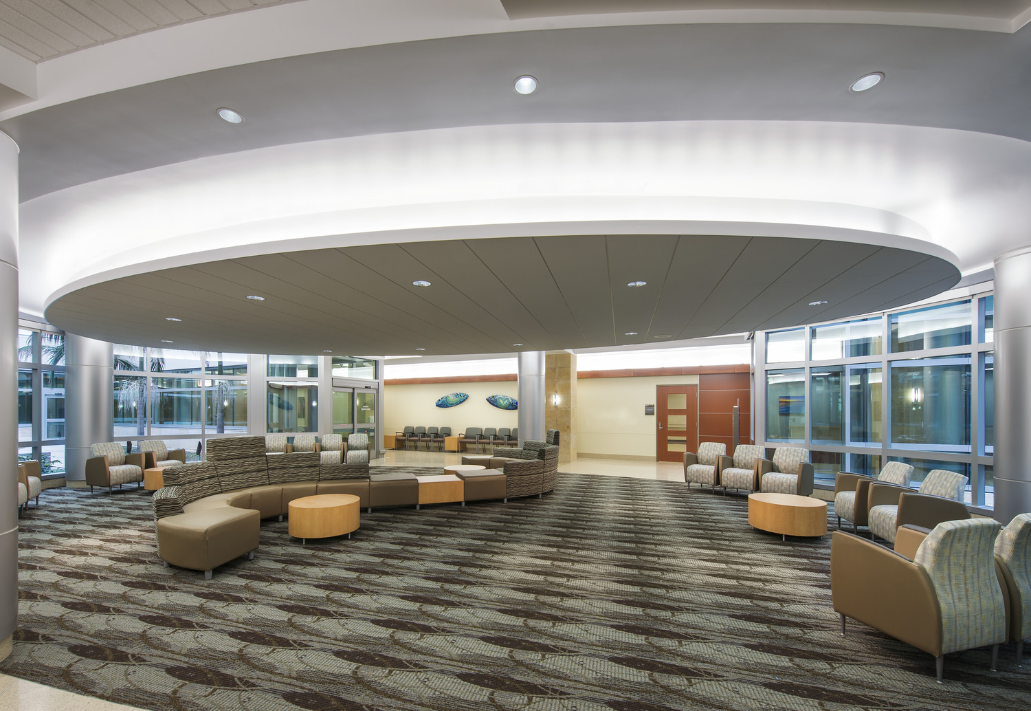 A large lobby with couches and chairs.