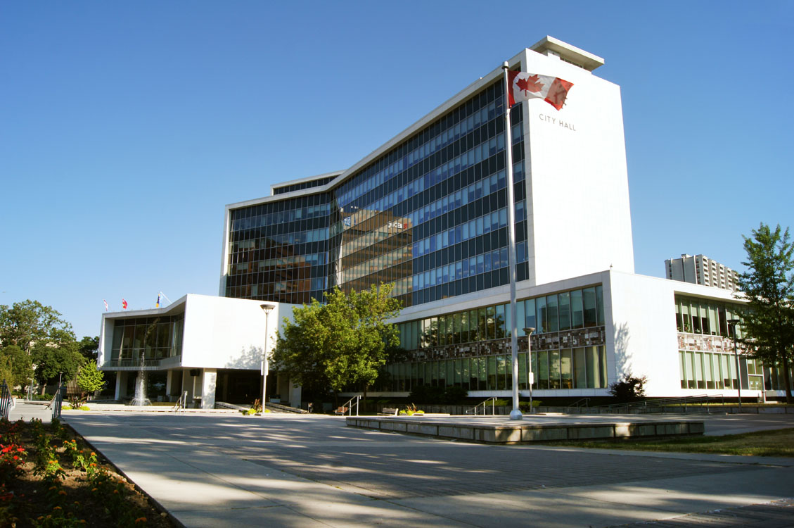 A white building with a blue sky.