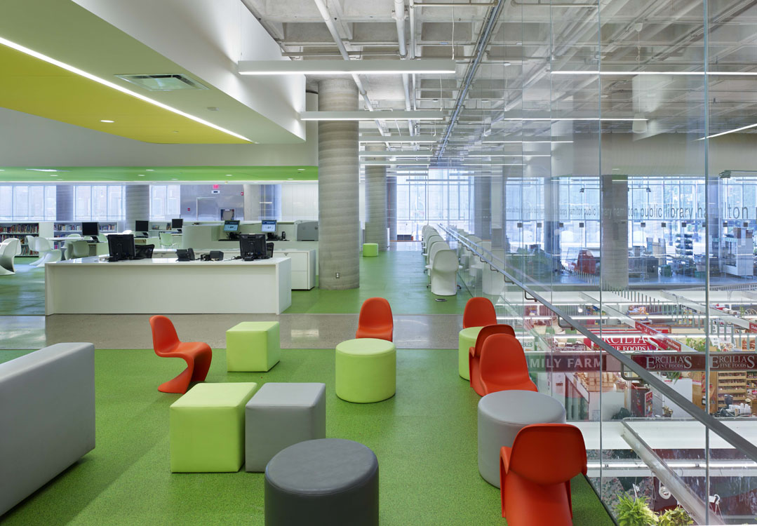 A modern office with colorful chairs and tables.