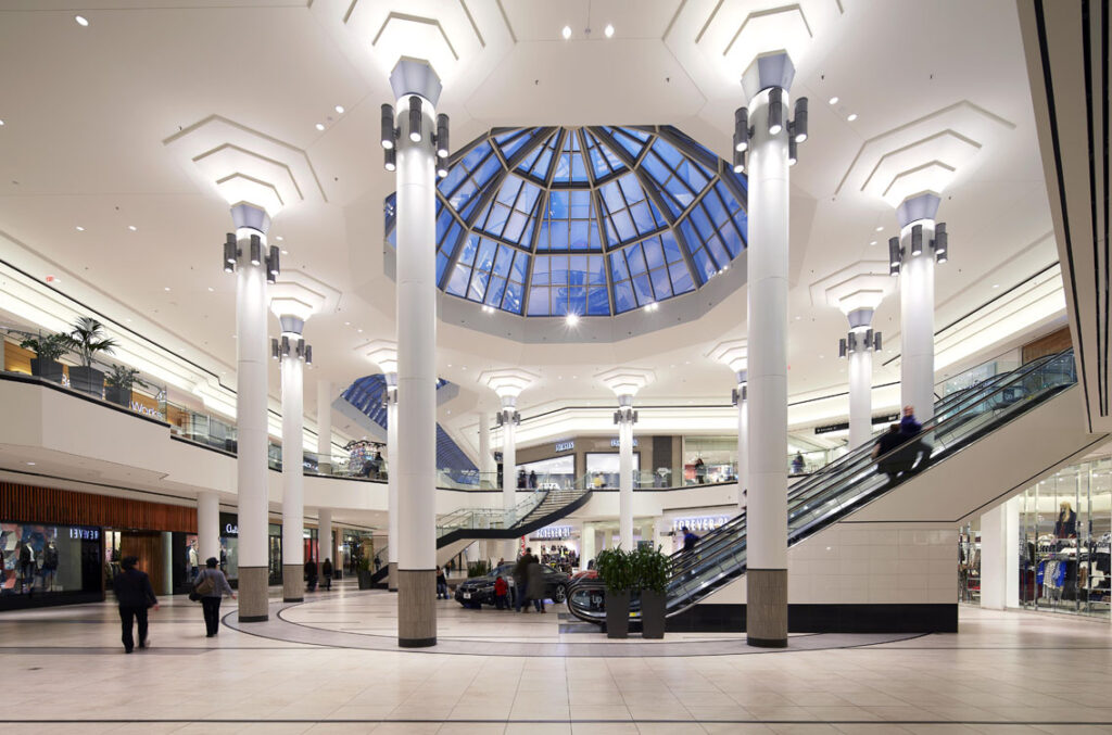 A large shopping mall with a skylight.