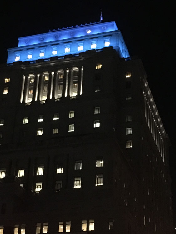 San francisco city hall lit up in blue.