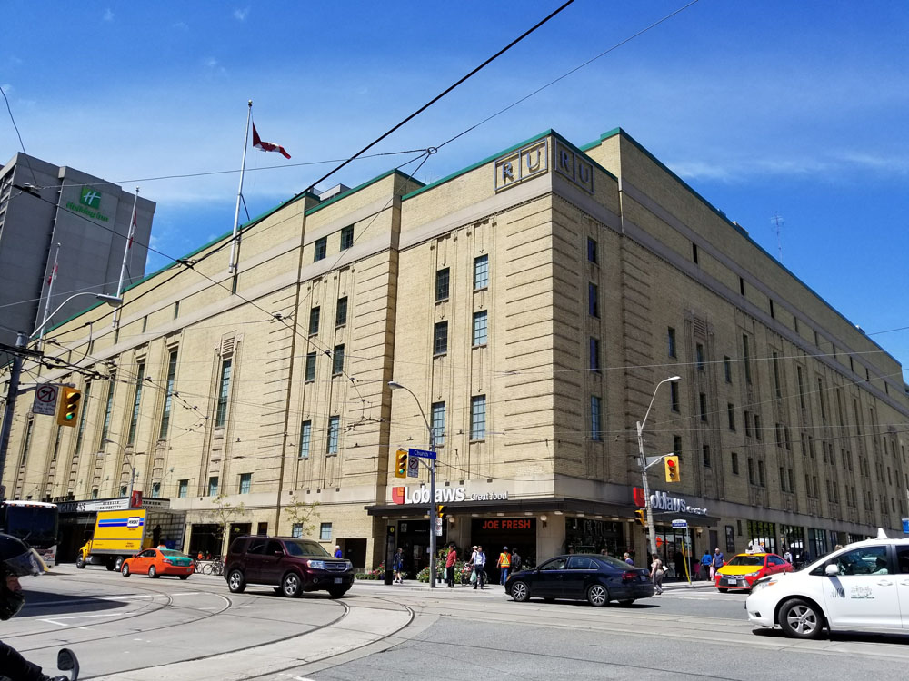 A large building on the corner of a street.