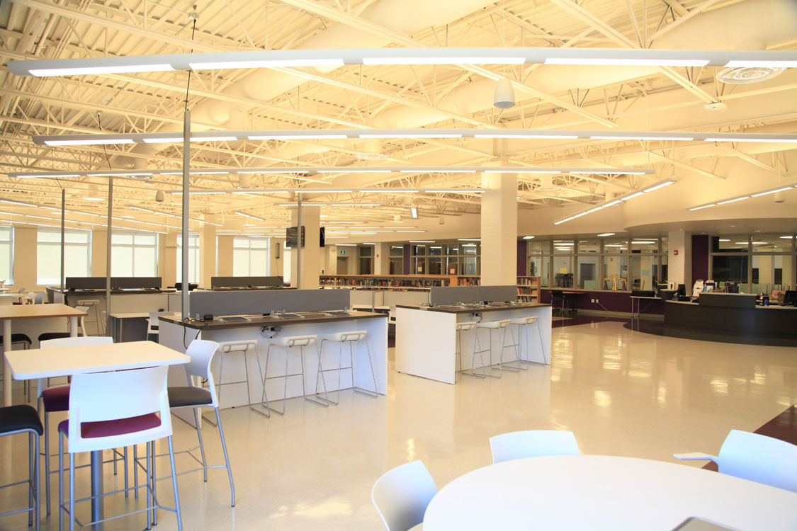 A large open space with white tables and chairs.