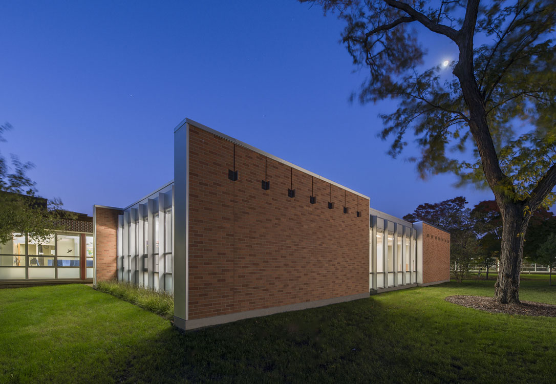 The exterior of a brick building at night.