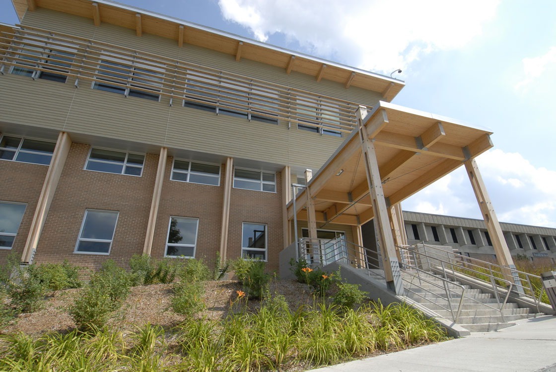 A building with stairs and a grassy area.