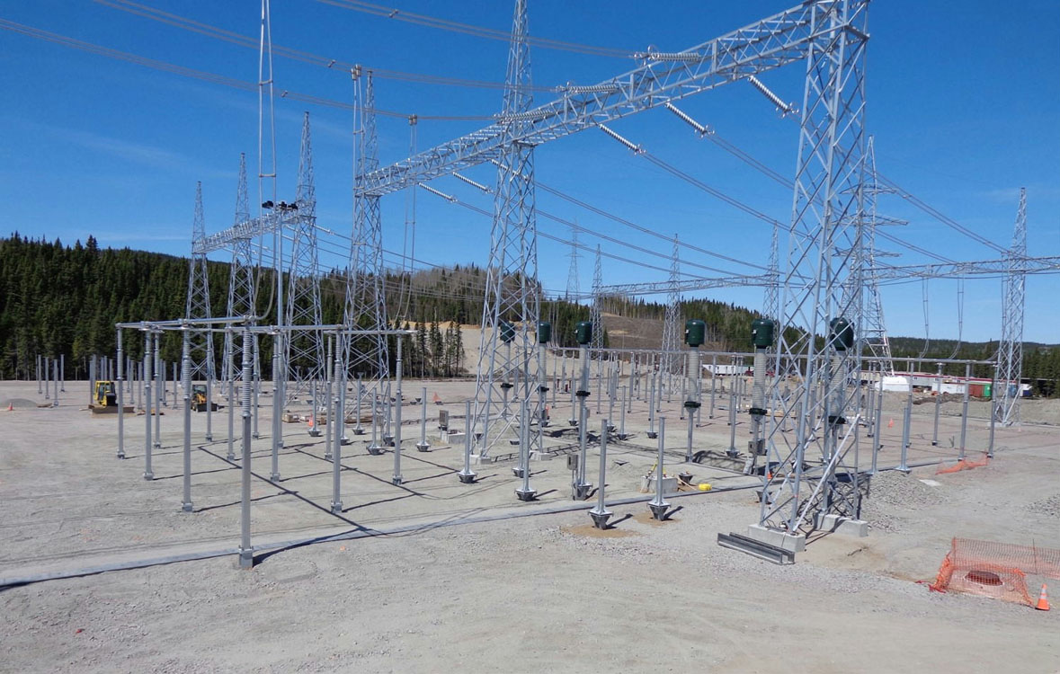 A large group of metal poles in the middle of a field.