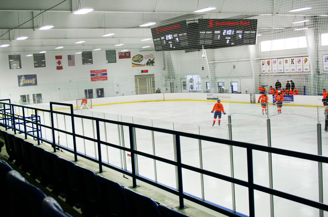 A hockey game is being played in a rink.