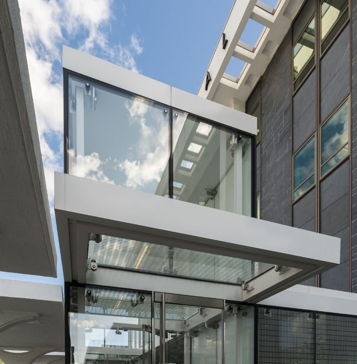 L'entrée d'un bâtiment moderne avec des murs en verre.