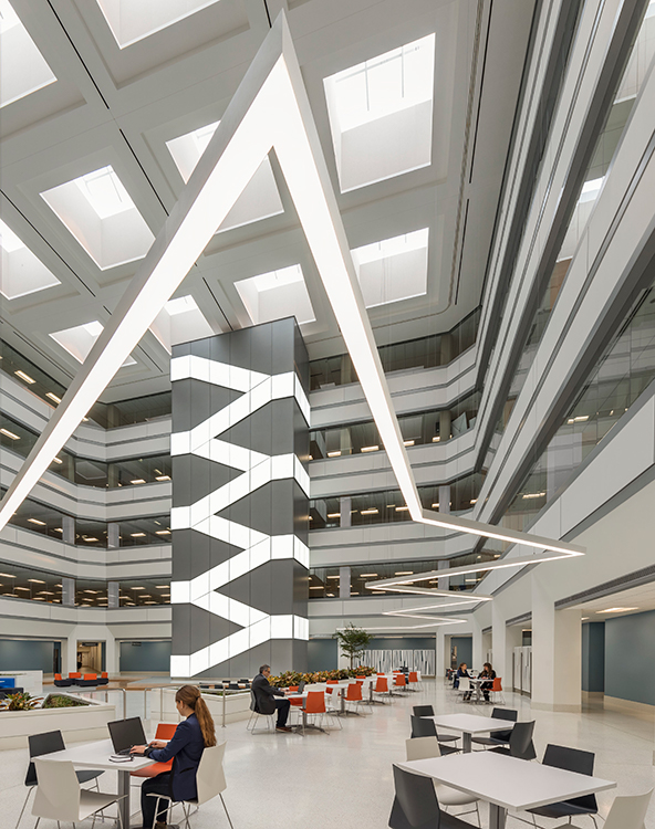 A large office building with people sitting at desks.