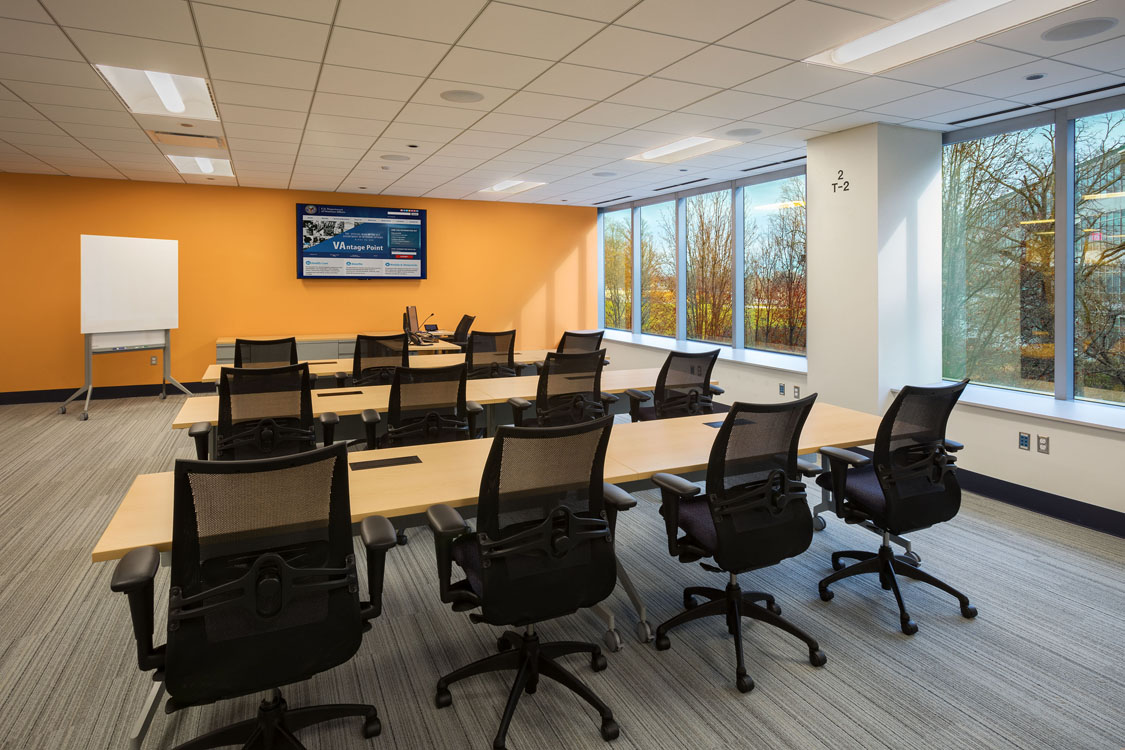 A conference room with tables and chairs.