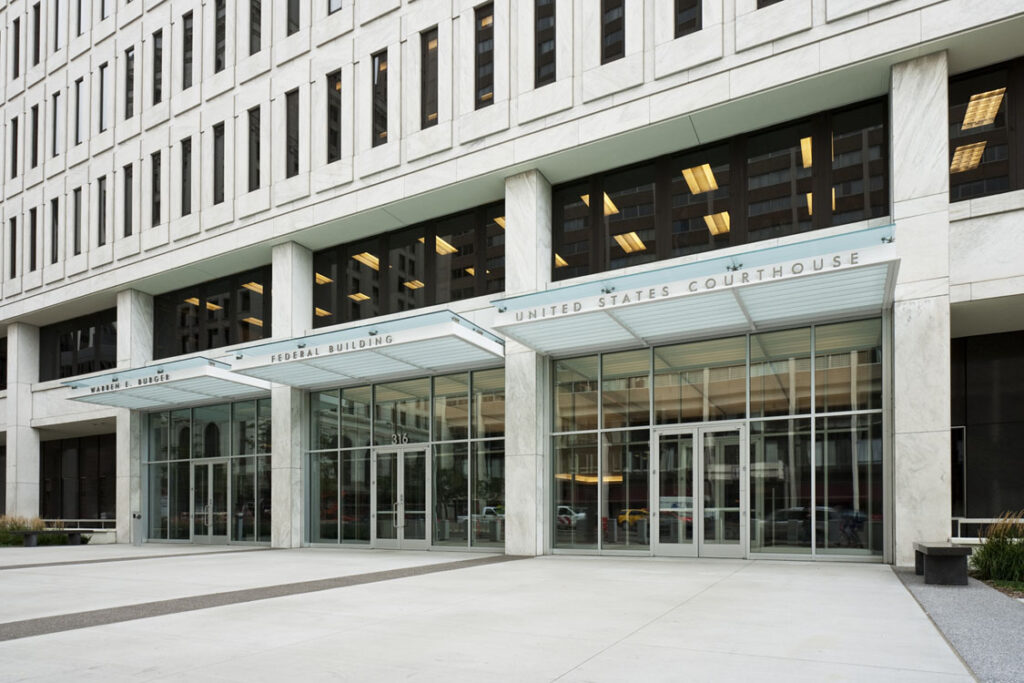 The entrance to a large building with glass doors.