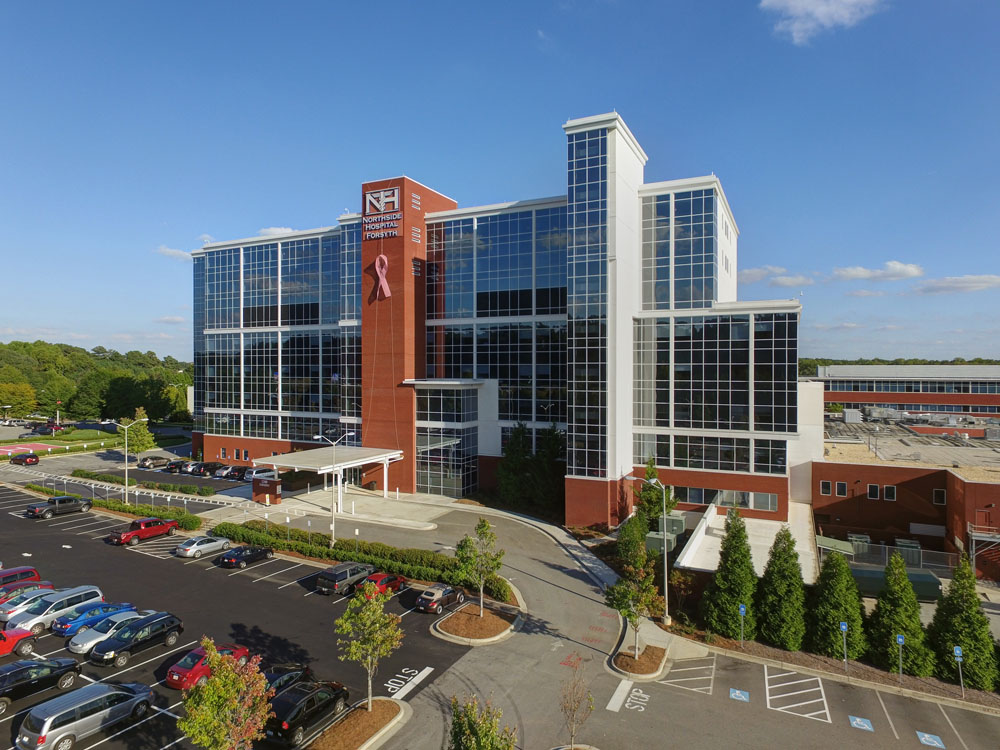 An aerial view of a large building in a parking lot.