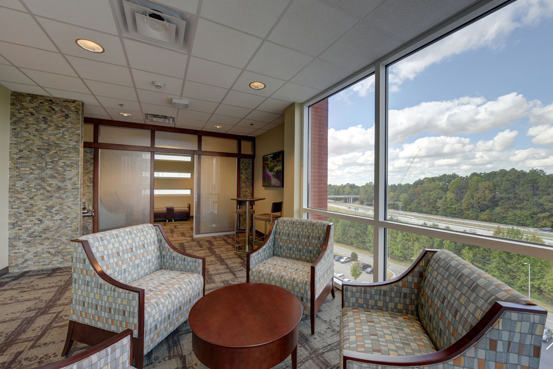 A waiting room with two chairs and a table.