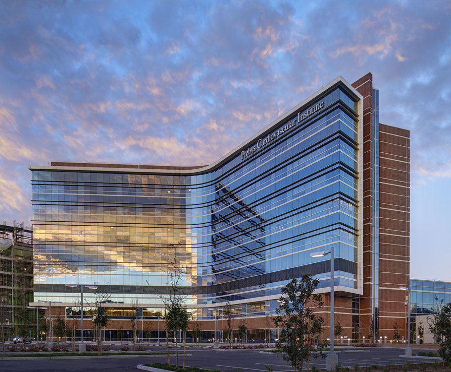 A building with a glass facade at dusk.