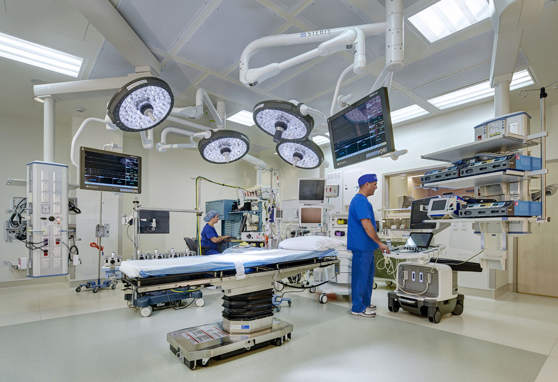 A hospital room with a bed and monitors.