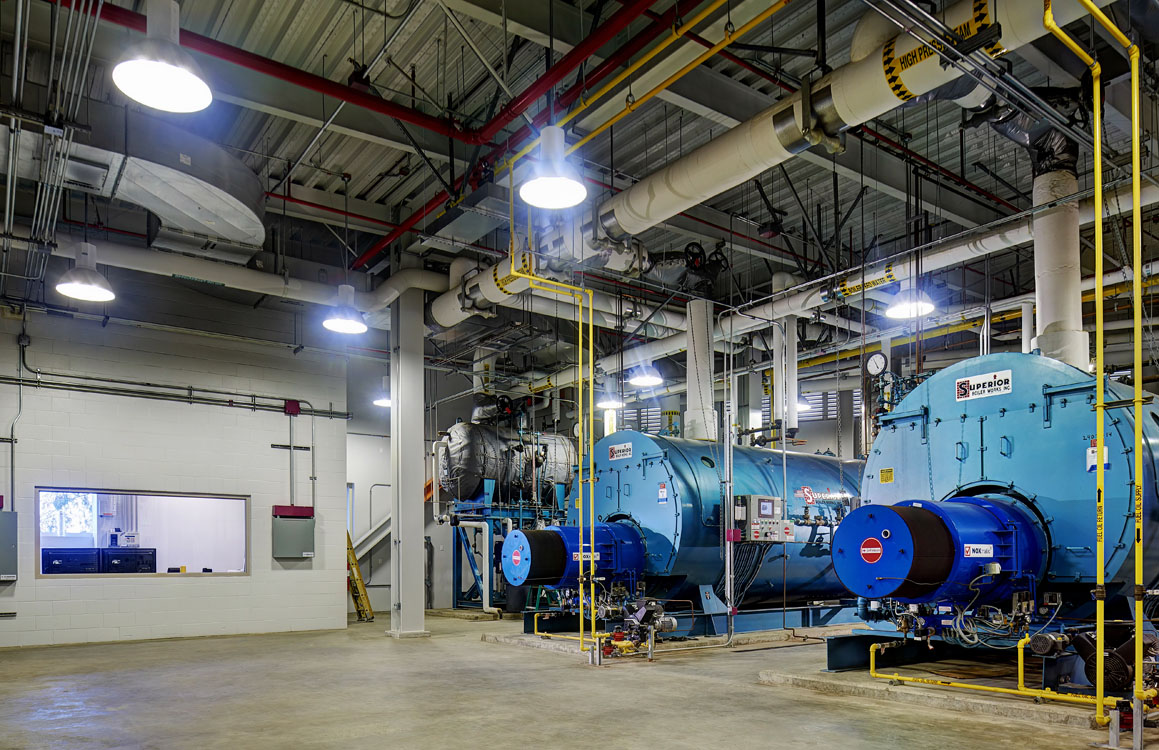 A large room with a large number of boilers.