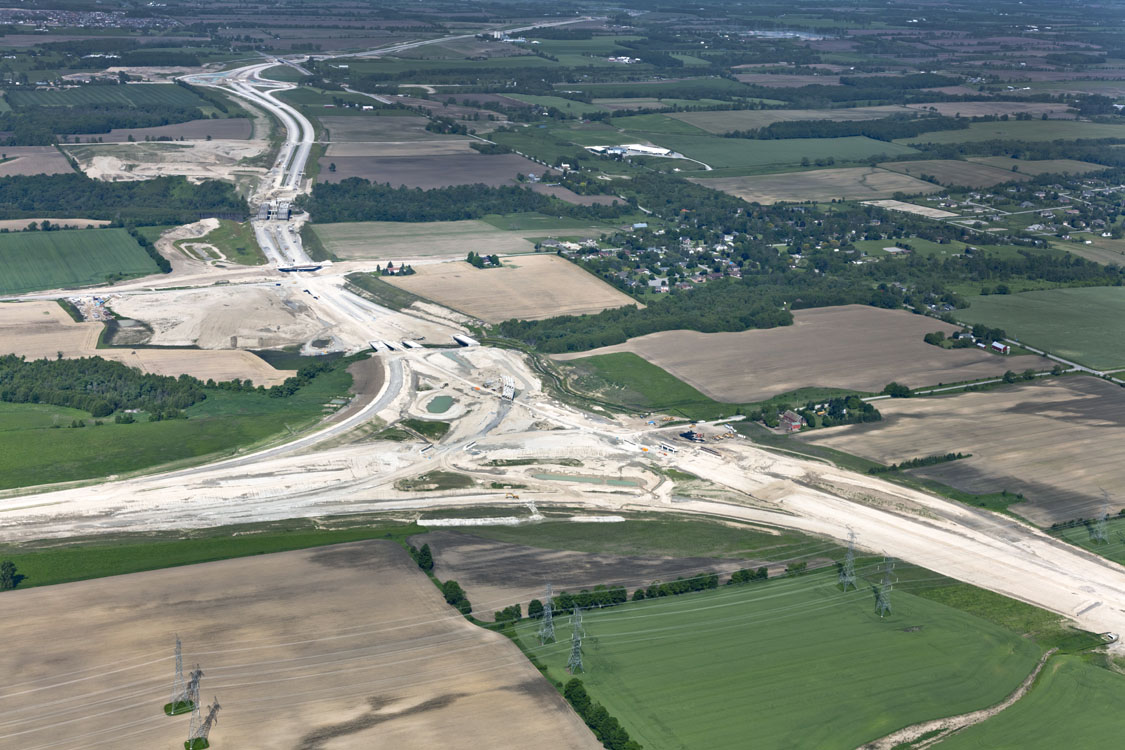 An aerial view of a highway over a field.