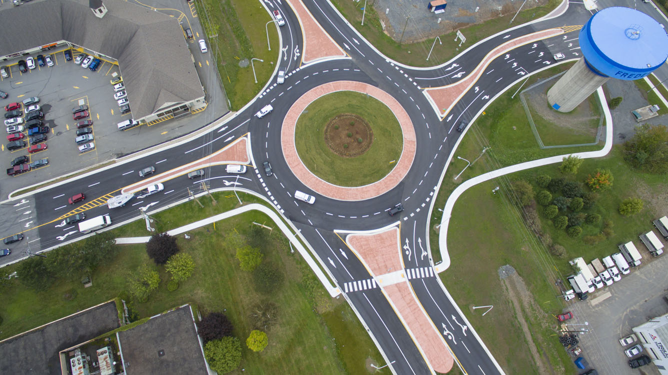An aerial view of a roundabout in a parking lot.