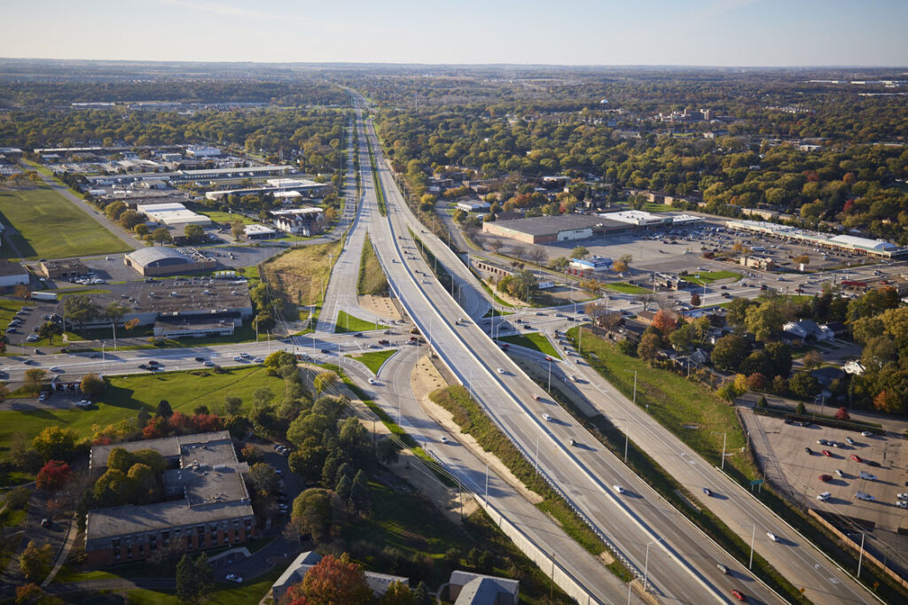 An aerial view of a highway and a city.