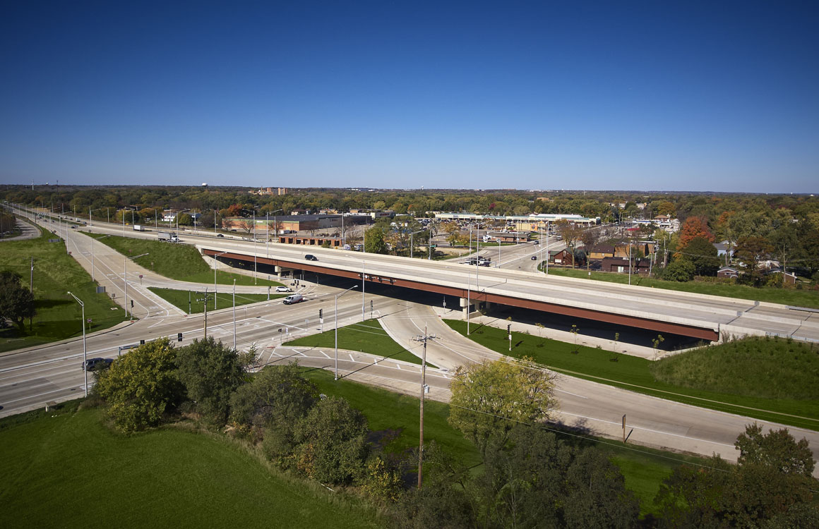 An aerial view of a highway with a bridge over it.