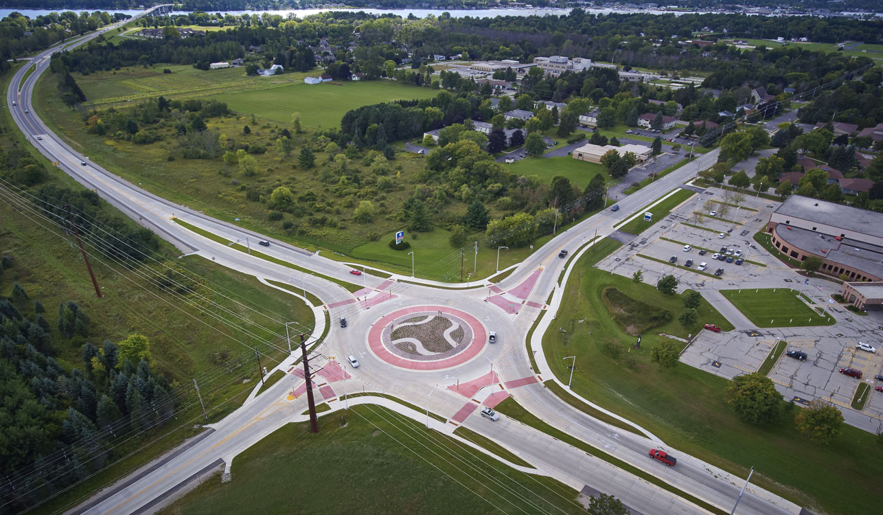 An aerial view of a roundabout in the middle of a field.