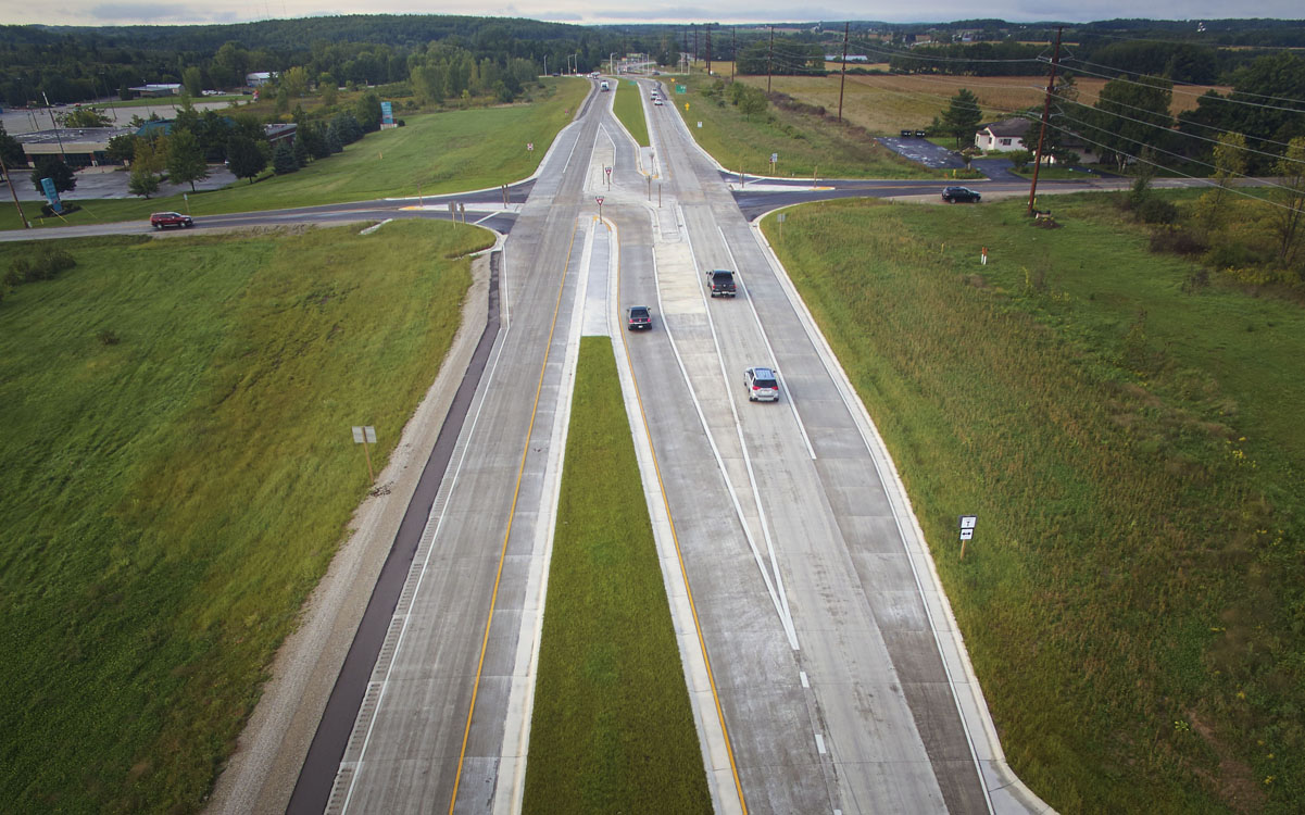 An aerial view of a highway with cars driving on it.