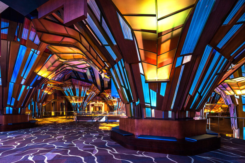 The lobby of a hotel is decorated with colorful stained glass.