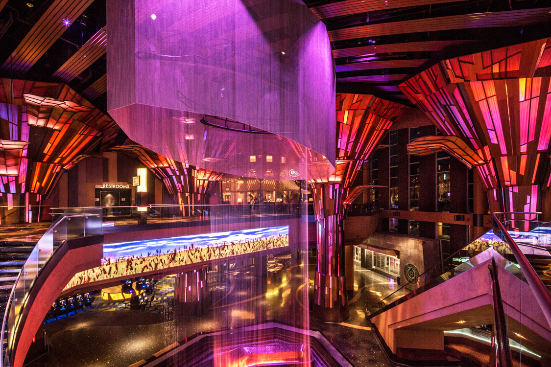 The inside of a casino with a purple light.