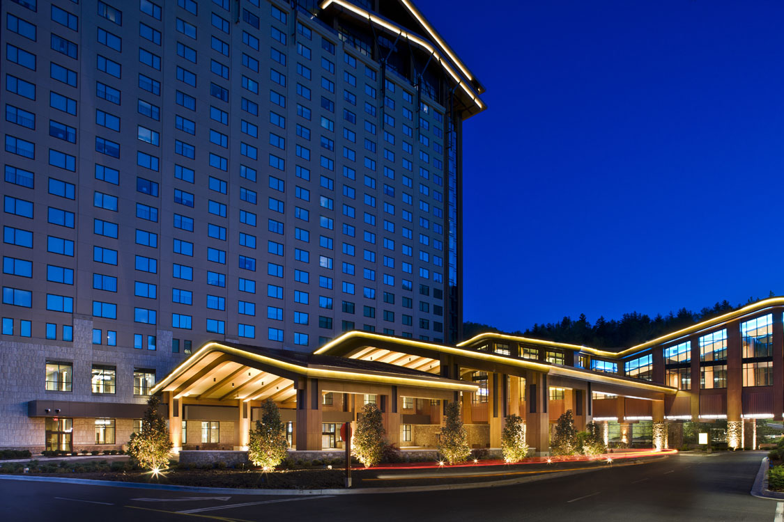 The front of a hotel at night.