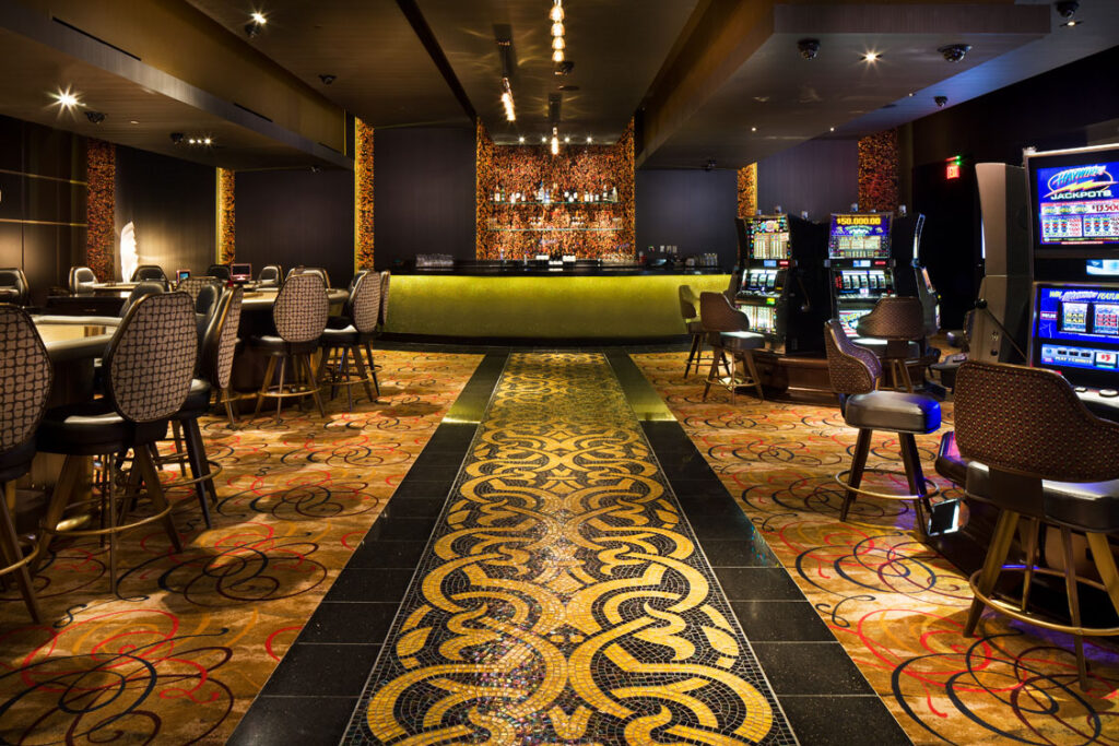 A casino floor with a large number of slot machines.
